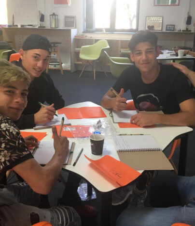 Fire gutter sitter rundt et bord og jobber med FROG-kurset